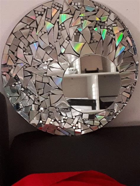 a mirror that is on the wall above a bed