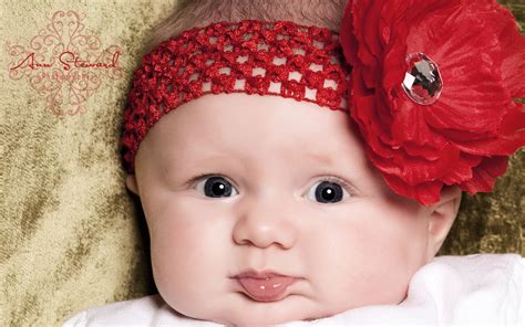 Wallpaper Of Super Baby: A Cute Baby With A Big Red Flower On Th Head | Free Wallpaper World