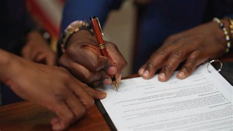 A Close up of a Man Signing a Document · Free Stock Video