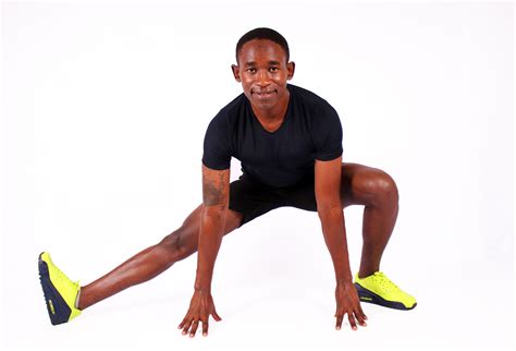 Smiling man stretching legs and hamstrings