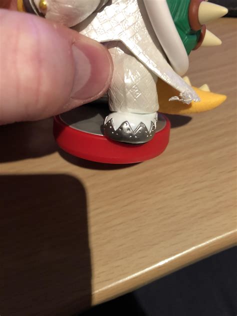 My Bowser (Wedding) Amiibo has a piece of tape on its coat tail that ...