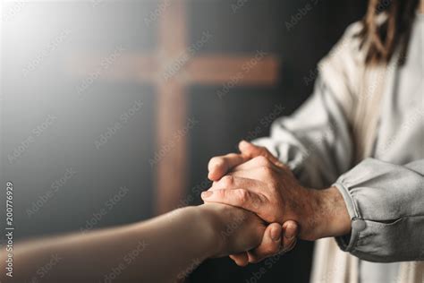 Jesus Christ gives a helping hand to the faithful Stock Photo | Adobe Stock