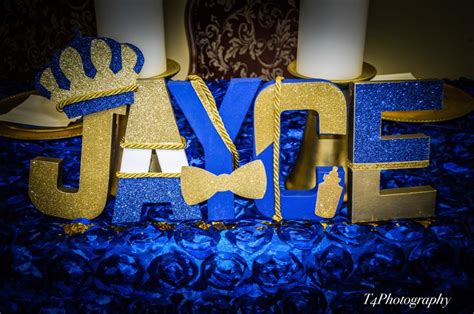 blue and gold wedding cake topper with the word love spelled out