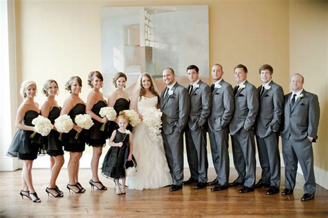 a group of people standing next to each other in front of a painting on ...