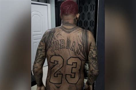 This guy got a full-size Michael Jordan jersey tattoo on his body