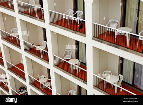 Hotel balconies with empty tables and chairs Stock Photo - Alamy