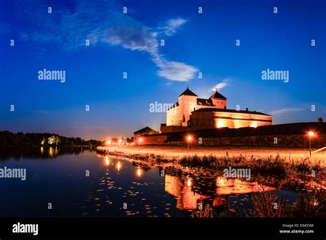 Medieval castle at night. Big blue sky above the castle and reflection ...