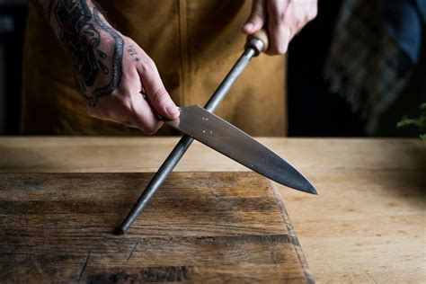 Professional chef sharpening knife kitchen | Premium Photo - rawpixel