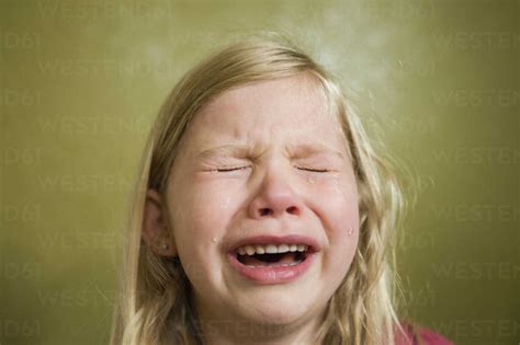 Sad girl crying at home stock photo