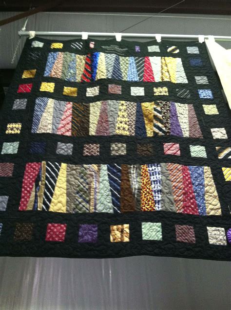 a quilt made to look like ties hanging on a clothes line