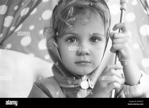 Kid holding umbrella Black and White Stock Photos & Images - Alamy