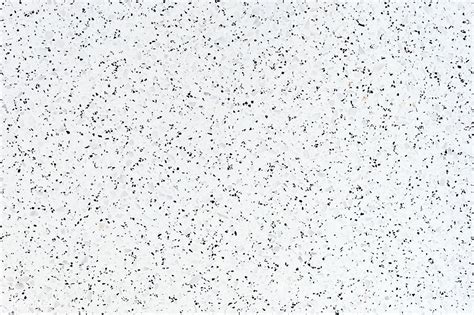 White granite textured tile with black stains | premium image by ...