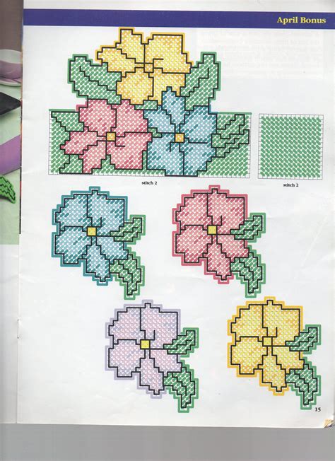 cross - stitch flowers are arranged in rows on a piece of paper with ...