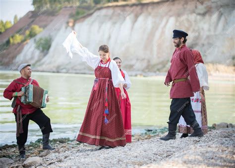 Premium Photo | Beautiful young people in russian national costumes ...