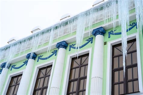 Premium Photo | Big icicles above the entrance to a residential building hanging icicles above ...