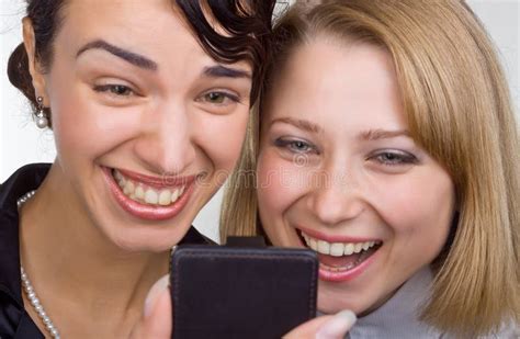 Two Laughing Women Look at Mobile Phone Stock Image - Image of portrait, caucasian: 21767515