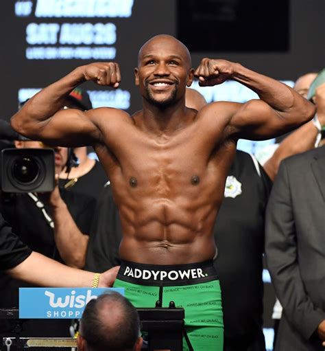 Boxer Floyd Mayweather Jr. poses on the scale during his official... | Floyd mayweather, Ufc ...