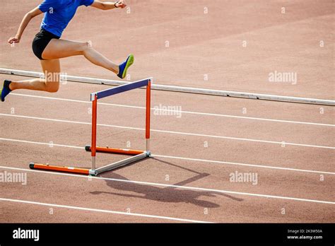 female athlete hurdling at stadium Stock Photo - Alamy