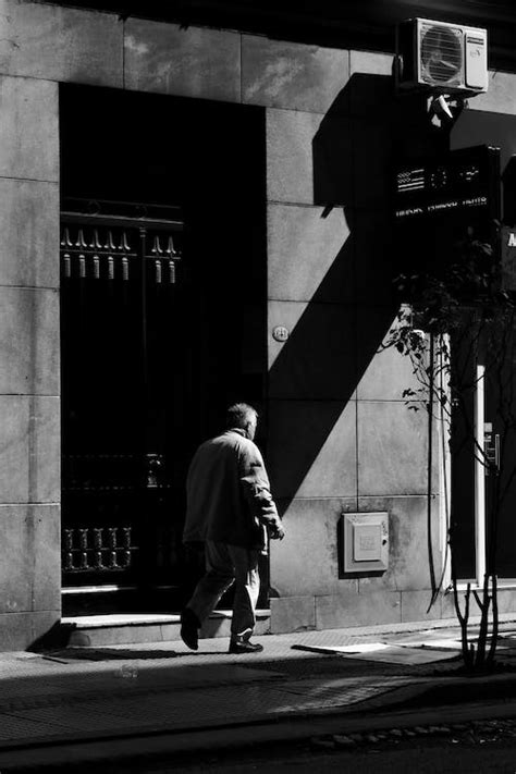 Pedestrian Walking along City Street · Free Stock Photo