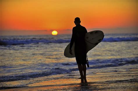 Surfer pauses to watch the sunset in Oceanside- August 19, 2012. | Beach scenes, Sunset, Beach life