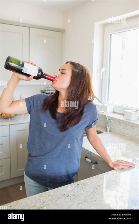 Woman drinking wine straight out of the bottle Stock Photo - Alamy