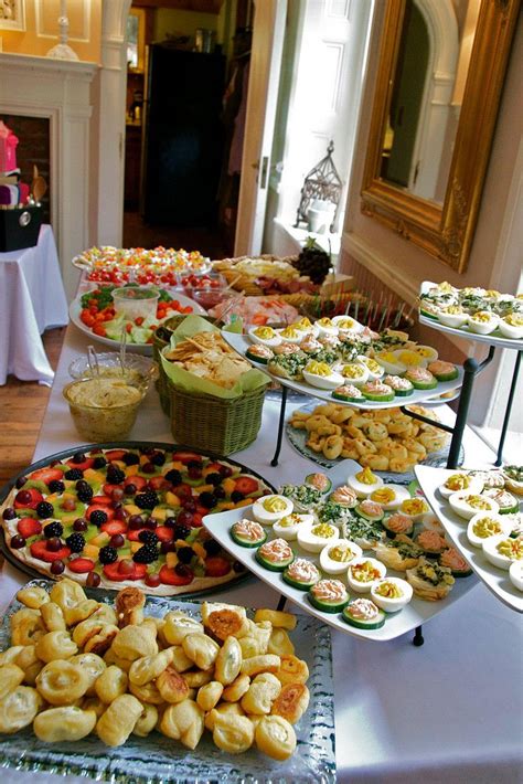 a table filled with lots of different types of food on top of plates ...