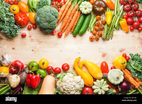 Fresh farm produce, organic vegetables on wooden pine table, healthy background, copy space for ...