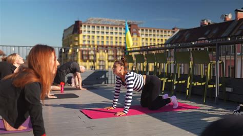 Woman instructs a yoga class on an outdoor deck 12771657 Stock Video at Vecteezy