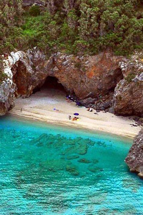 the water is blue and clear with people swimming in it at the beach ...