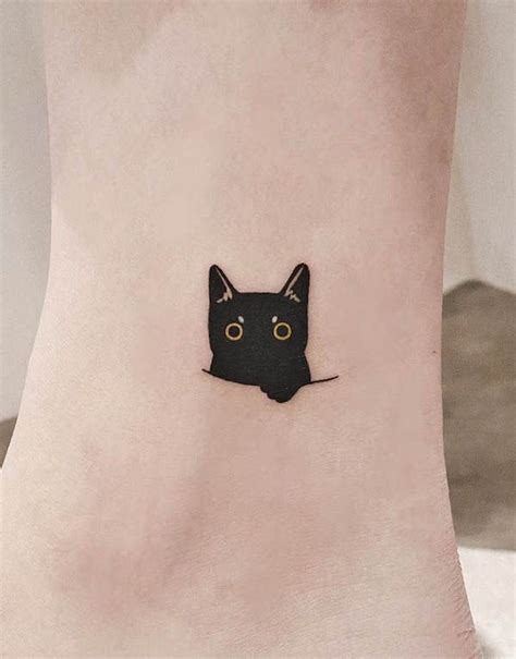 A small black cat tattoo by @tattoo_artist_olive- Minimalist tattoos for cat lovers | Cat tattoo ...