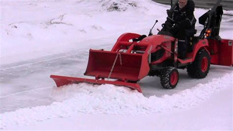 Snow blower, plow and bucket on Kubota BX clearing hard snow - YouTube