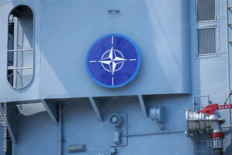 The logo sign of NATO placed on a military vessel ship. North Atlantic ...