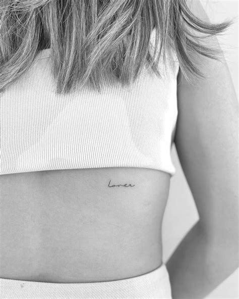 "lover" - lettering tattoo on the back