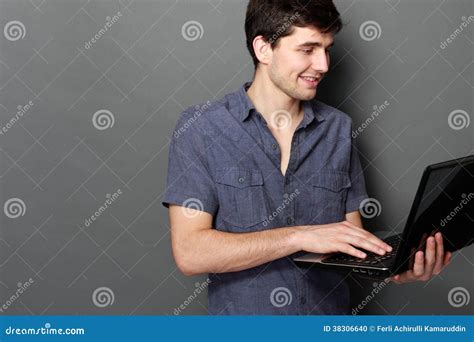 Young Male Smiling Using Laptop Computer Stock Photo - Image of casual, portrait: 38306640