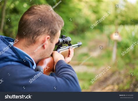 Young Man Shoot With Air Rifle. Stock Photo 421653283 : Shutterstock