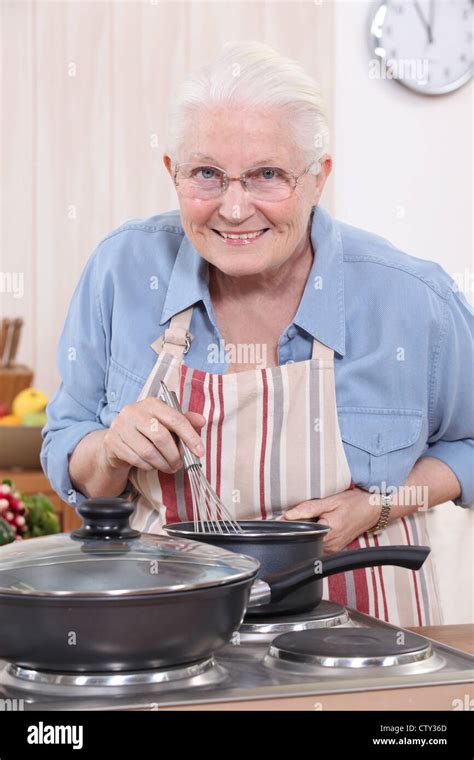 Old woman cooking Stock Photo - Alamy