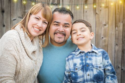 Young Mixed Race Family Portrait Outside Near String Lights | UCLA Luskin Center for Innovation