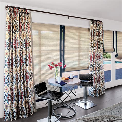 Layered window treatments, these natural woven shades and curtains offer privacy and light ...