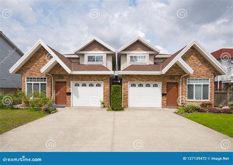 Residential Duplex Building with Concrete Drive Way and Green Lawns in ...