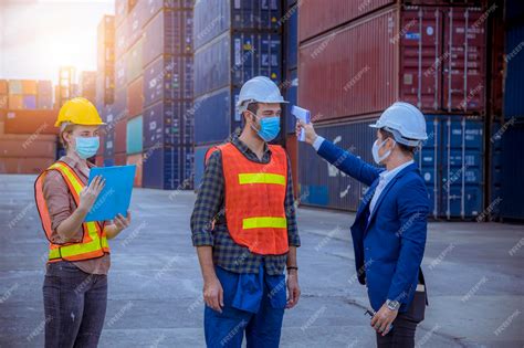 Premium Photo | Portrait team dock workers posing under working and checking production process ...