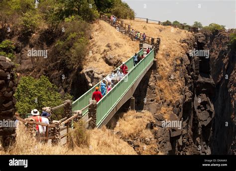 Visitors crossing Knife-edge bridge Victoria Falls Livingstone Zambia ...