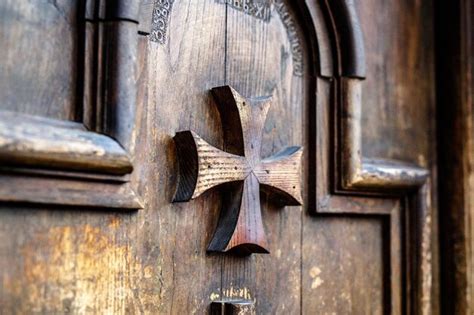 Premium Photo | Old wooden door with maltese crosses close-up