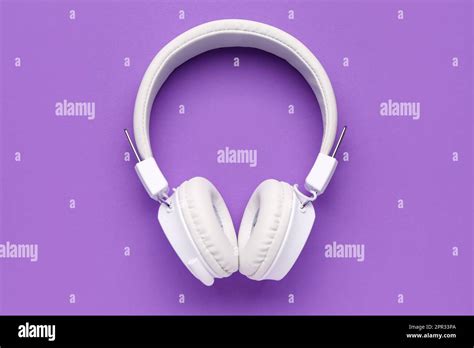 Modern white headphones on purple background Stock Photo - Alamy