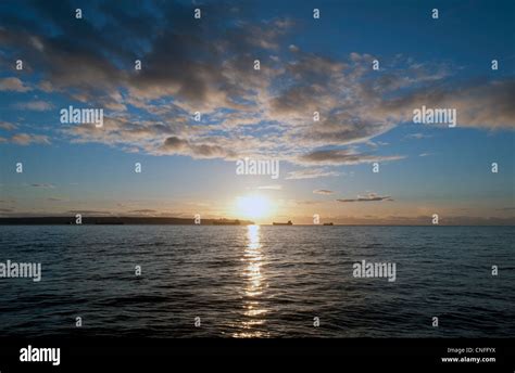 Sea with sunset and clouds Stock Photo - Alamy