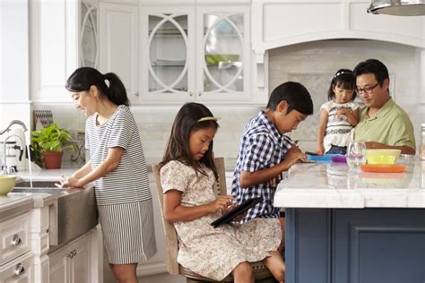 Family In Kitchen Doing Chores And Using Digital Devices - Sensory Stepping Stones