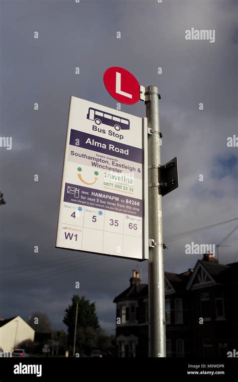 A Bus stop sign at Alma road Romsey shot low down against a stormy sky ...