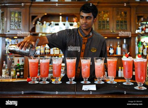 Bartender at Raffles hotel in Singapore making the famous Singapore ...