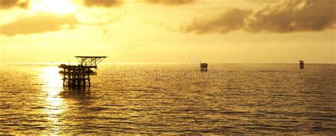 Offshore oil rig at sunset stock image. Image of sustainable - 261279865