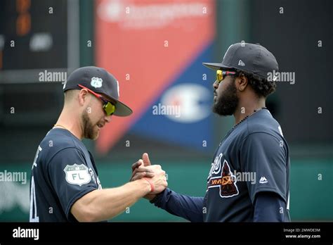 Atlanta Braves infielders Brandon Phillips, right, and Ender Inciarte shake hands while ...