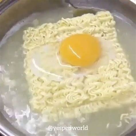 an egg on top of noodles in a frying pan